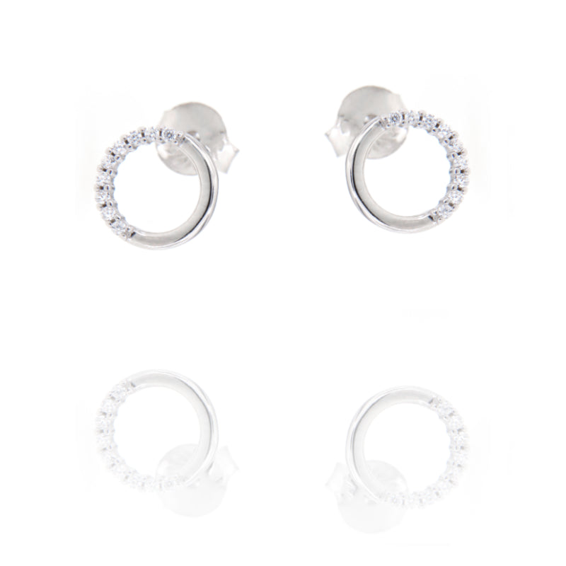 A pair of silver-toned stud earrings, each featuring an open circle design. One arc of the circle is smooth, the other is set