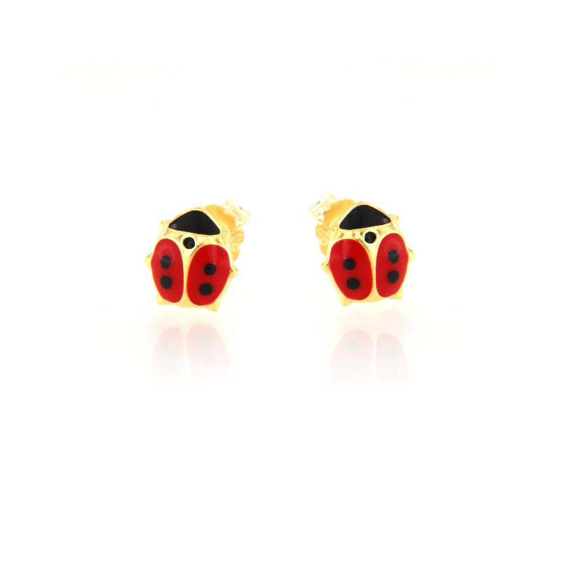 Pair of gold-toned stud earrings shaped like ladybugs, with red and black enamel detailing on a white background.