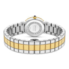 Back of a watch with a silver-toned case, gold-toned bezel, and crown with a dark blue stone. Two-toned silver and gold-toned
