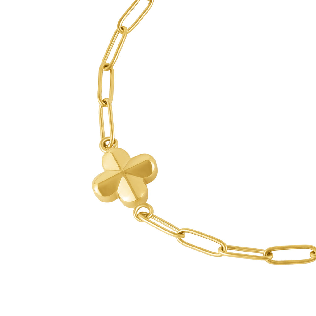 Gold-toned paperclip chain bracelet with a dimensional four-leaf clover charm.