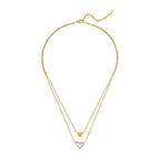 Gold-toned duochain necklace with a small solid heart pendant featuring an etched design and a larger open heart pendant outl
