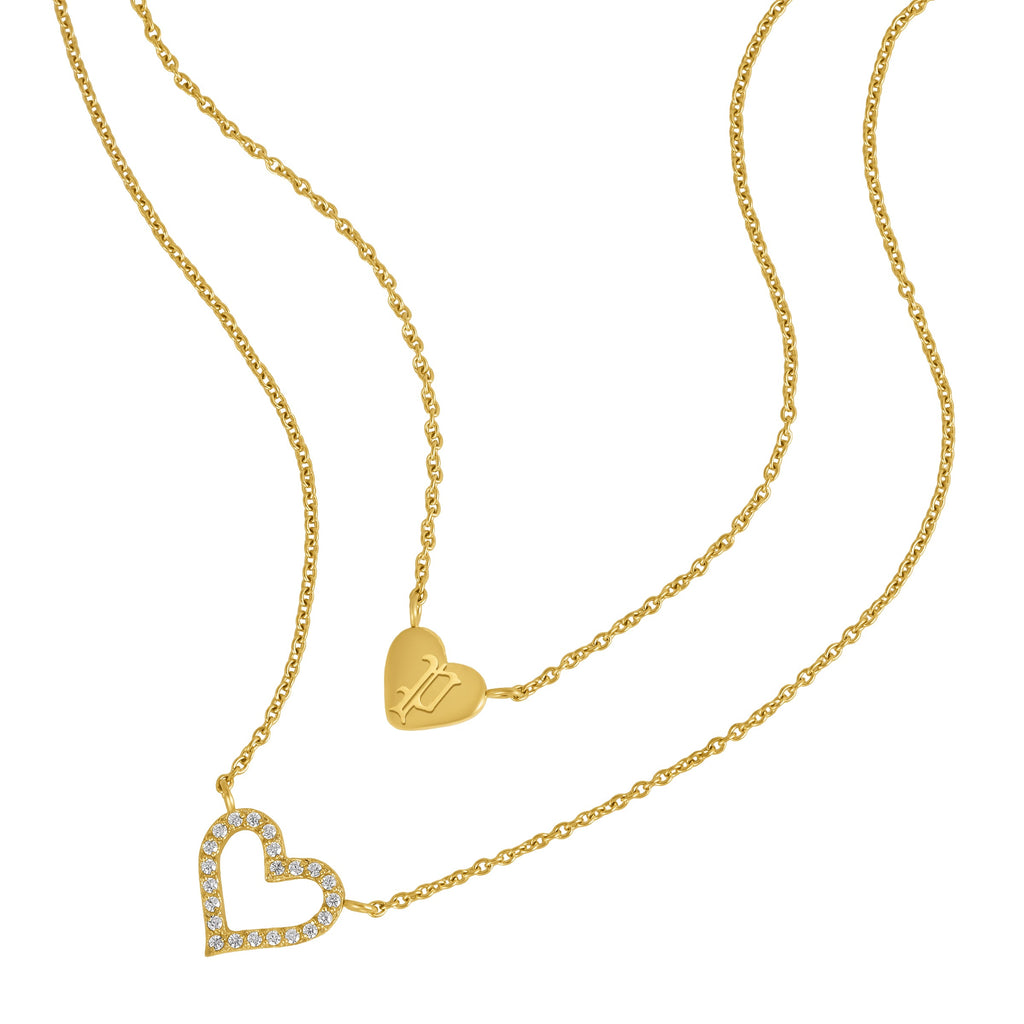 Gold-toned duochain necklace with two heart pendants, one solid with an engraved 'P' and one open heart with clear crystals.