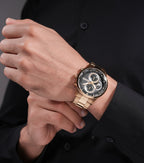Round gold-toned watch with a black textured dial, three sub-dials, gold-toned hands, and a gold-toned link bracelet.