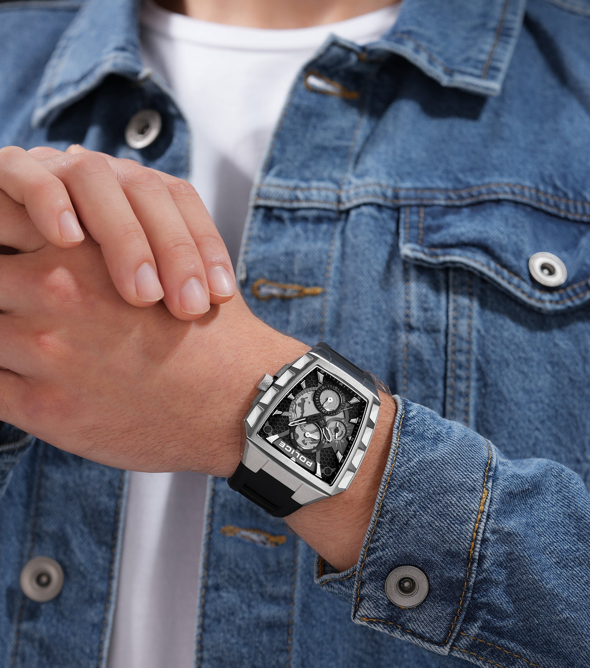 Silver-toned angular watch with black dial, visible gears, three subdials, and a black silicon strap.