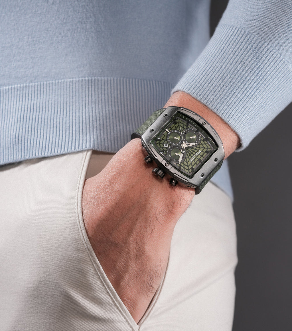 Gunmetal-toned rectangular watch with a green geometric dial, three subdials, black silicon pushers, and a green nylon strap.