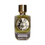 Clear glass perfume bottle with olive green liquid, an ornate black and white circular label, and a gold-toned cap.