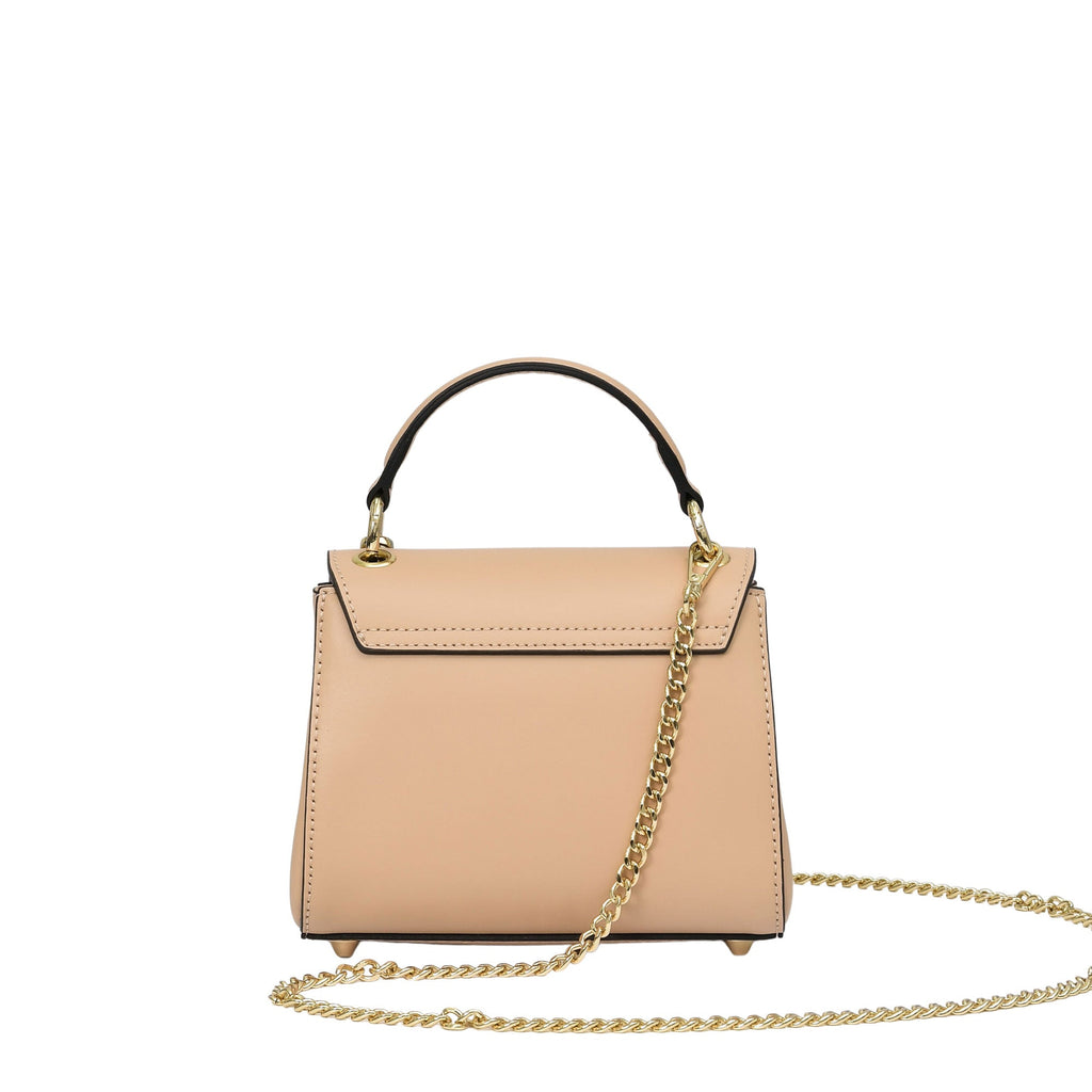 Nude structured leather top-handle bag with a black handle, gold-toned hardware, a long gold-toned chain strap, and four feet