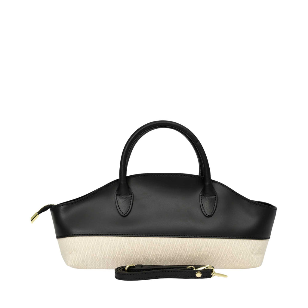 Structured black leather and beige canvas handbag with two top handles, a side zipper, and a detachable black strap with gold