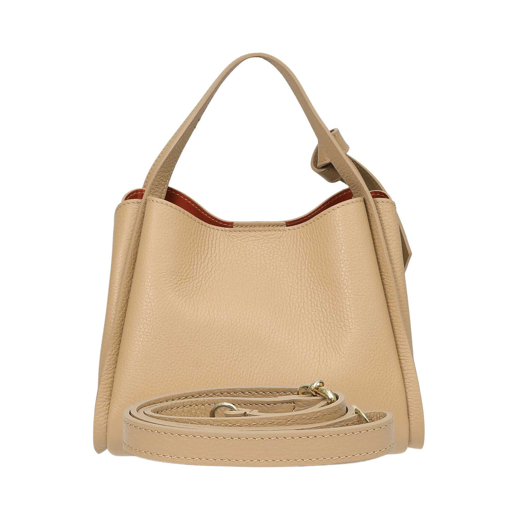 Warm beige pebbled leather bucket bag with a single top handle, an orange lining, and a coiled detachable shoulder strap with