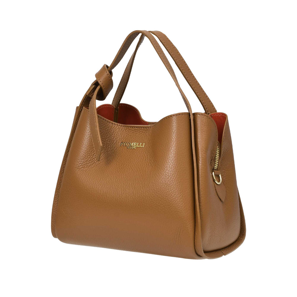 Warm brown pebbled leather handbag with two top handles, one knotted. Features a gold-toned logo, side zipper, and orange lin
