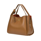 Warm brown pebbled leather handbag with two top handles, one knotted. Features a gold-toned logo, side zipper, and orange lin