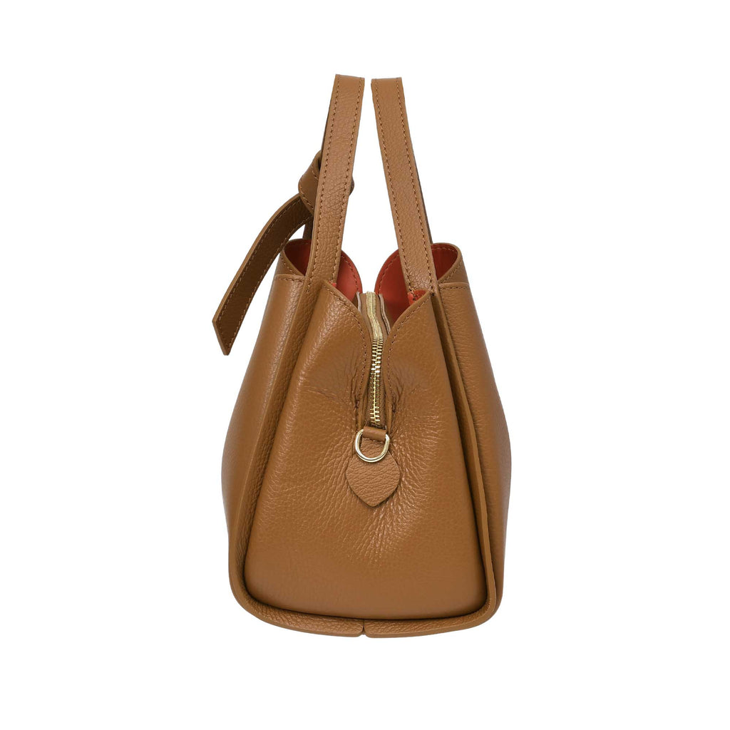 Warm brown pebbled leather handbag with two top handles, one knotted, gold-toned zipper with D-ring pull, and orange lining.