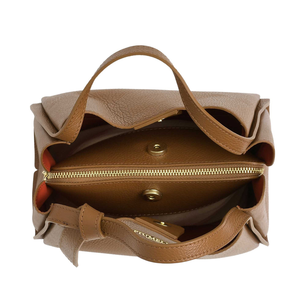 Warm brown pebbled leather handbag with two top handles, gold-toned zipper, magnetic snaps, and orange interior lining.