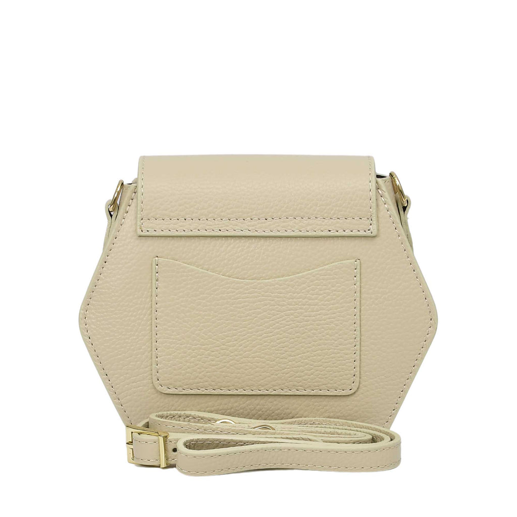 Ivory pebbled leather hexagonal bag with a flap closure, a back slip pocket, and an adjustable strap with gold-toned hardware