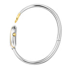 A side profile photograph accentuating the complete circular architecture of the polished rigid steel bangle, the integrated rear case hinge, and the fluted yellow gold setting crown on the side of the horseshoe watch head.