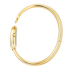 A side profile shot showcasing the complete circular architecture of the polished gold-plated rigid bangle, the integrated case hinge, and the fluted crown detailed on the side of the horseshoe watch head.