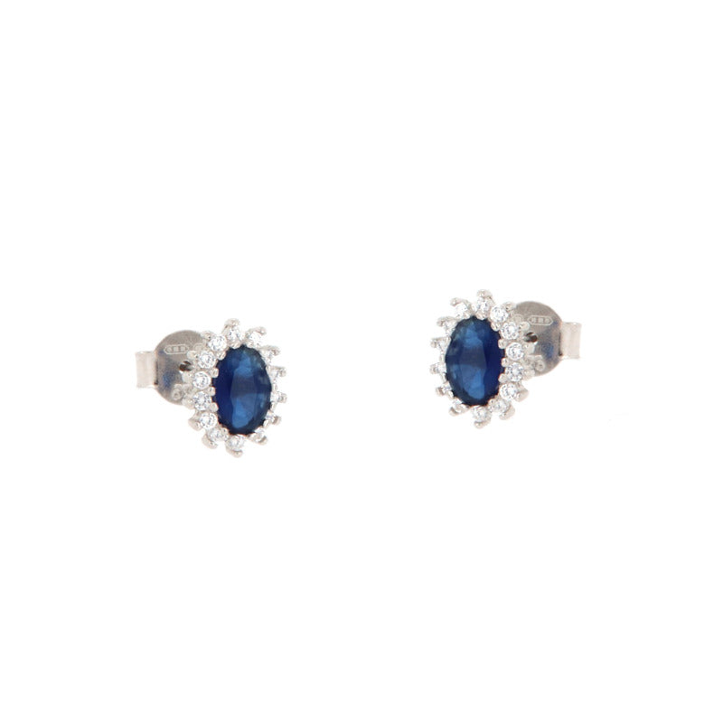 Pair of silver-toned stud earrings, each with an oval dark blue stone surrounded by a halo of small clear stones.