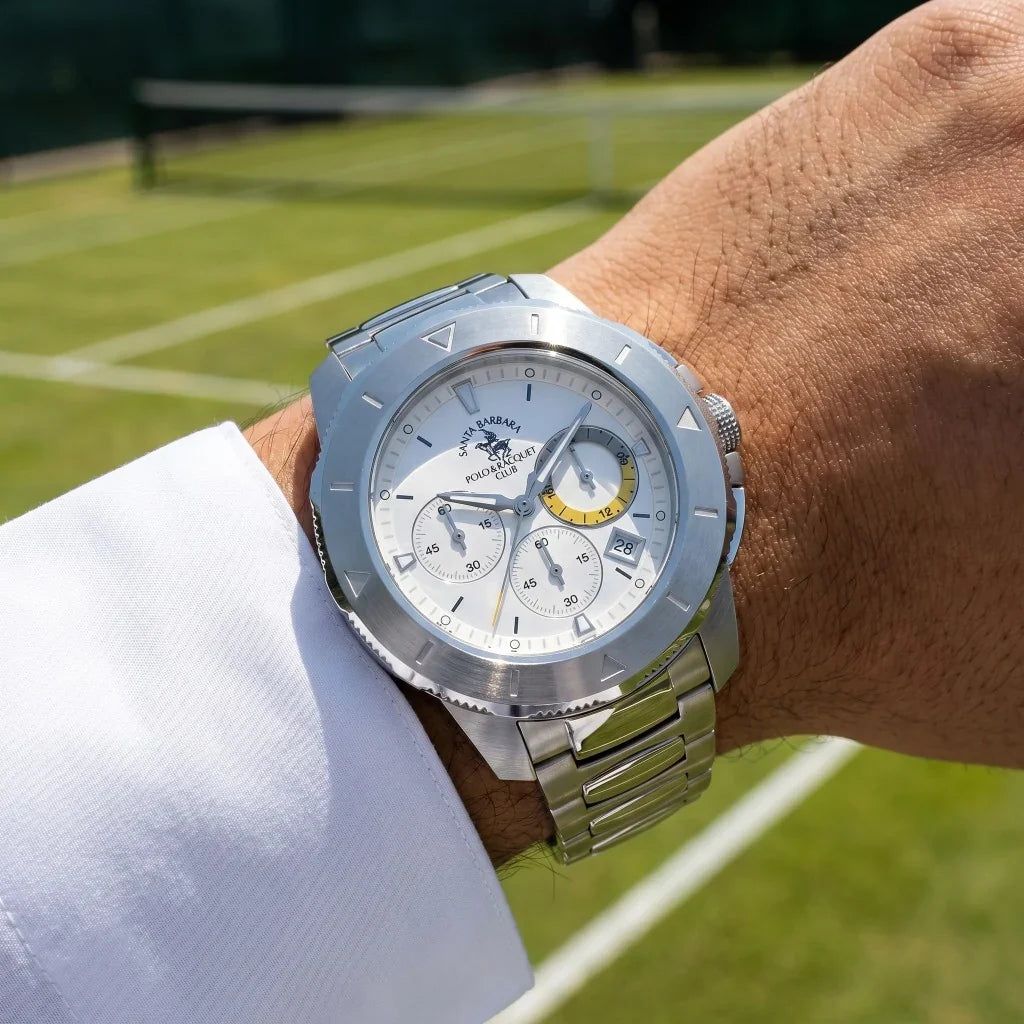 Silver-toned metal watch with a white chronograph dial, yellow accent on one sub-dial, date window, and link bracelet.