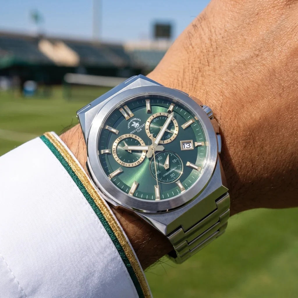 Silver-toned octagonal watch with a deep green sunburst dial, gold-toned markers, hands, and three sub-dials, and a silver-to