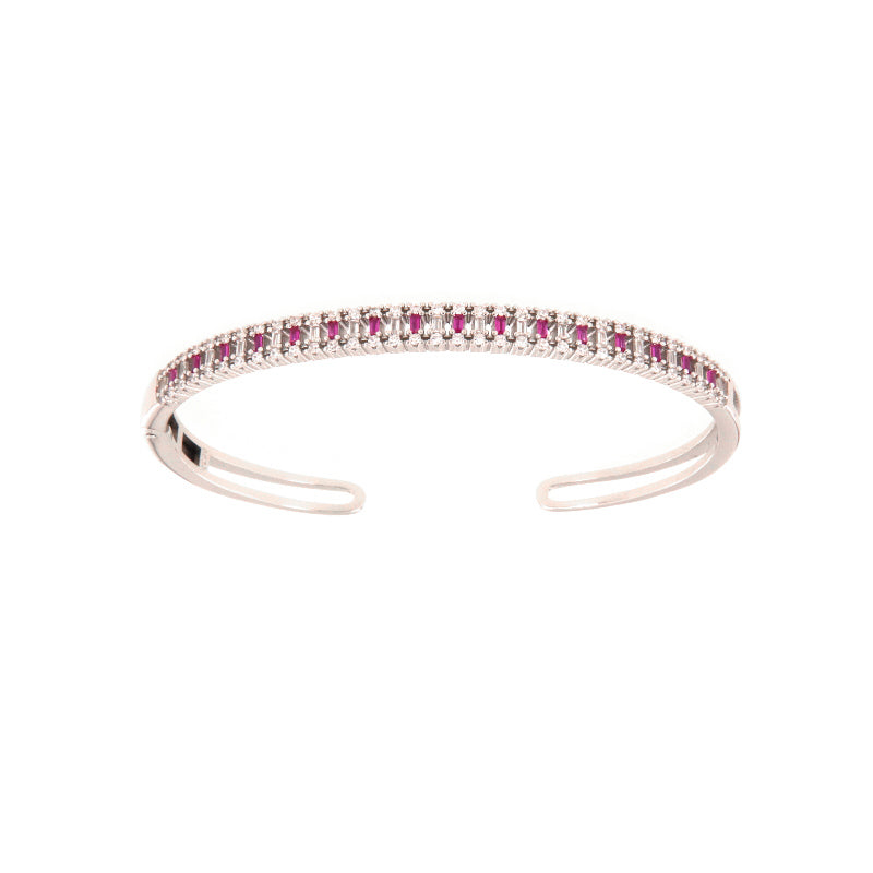 Silver-toned open cuff bangle with a top row of rectangular ruby-colored stones flanked by clear round stones.