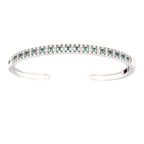 Silver-toned open bangle with a top row of alternating clear and green baguette stones.