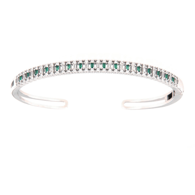 Silver-toned open bangle with a top row of alternating clear and green baguette stones.