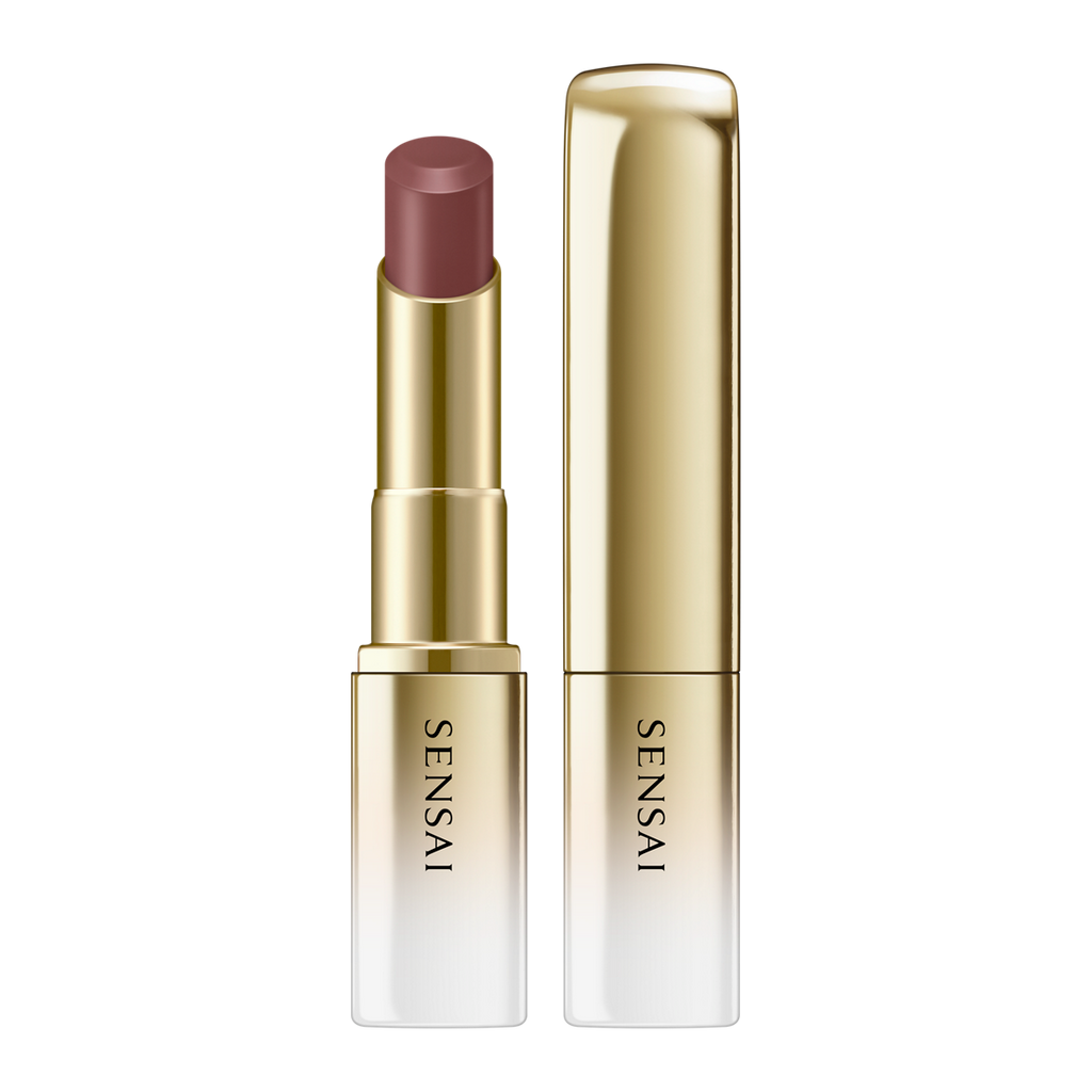 Sensai lipstick with gold casing on a white background.