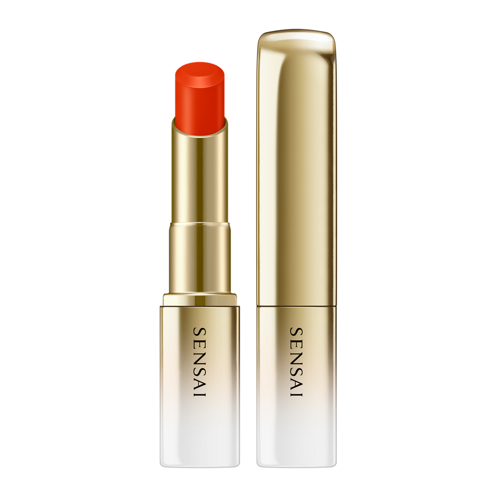 Sensai lipstick with red cap and gold casing on a white background.