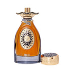 Amber perfume bottle with gold-toned ornate collar and emblem. Detached gold-toned cap has a black honeycomb pattern.
