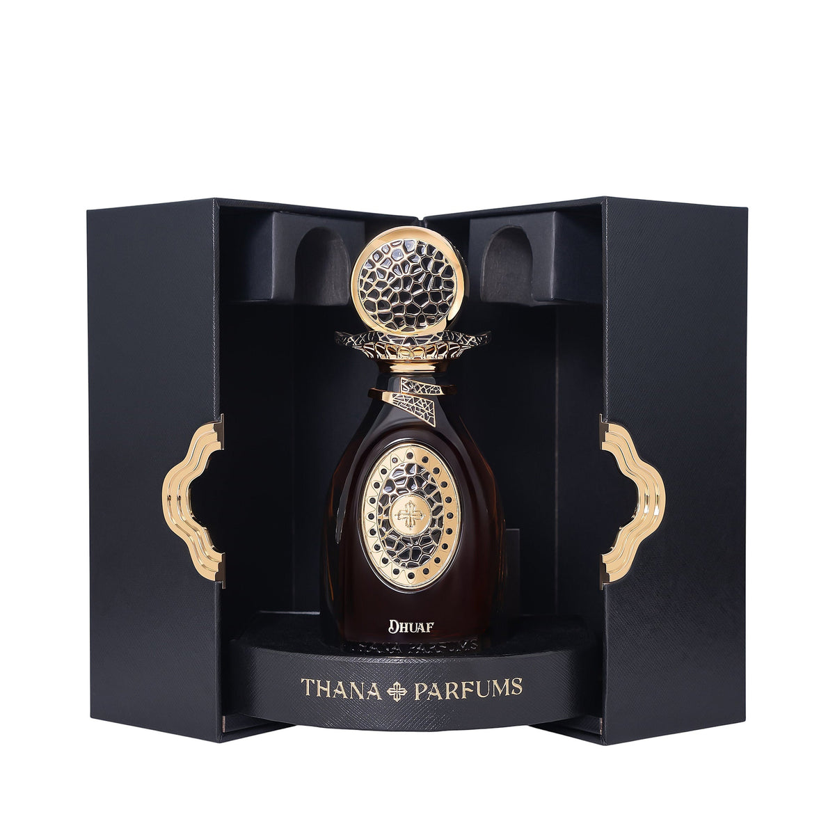 Dark amber perfume bottle with a gold-toned ornate cap and front design, displayed in a black textured box with gold-toned wa