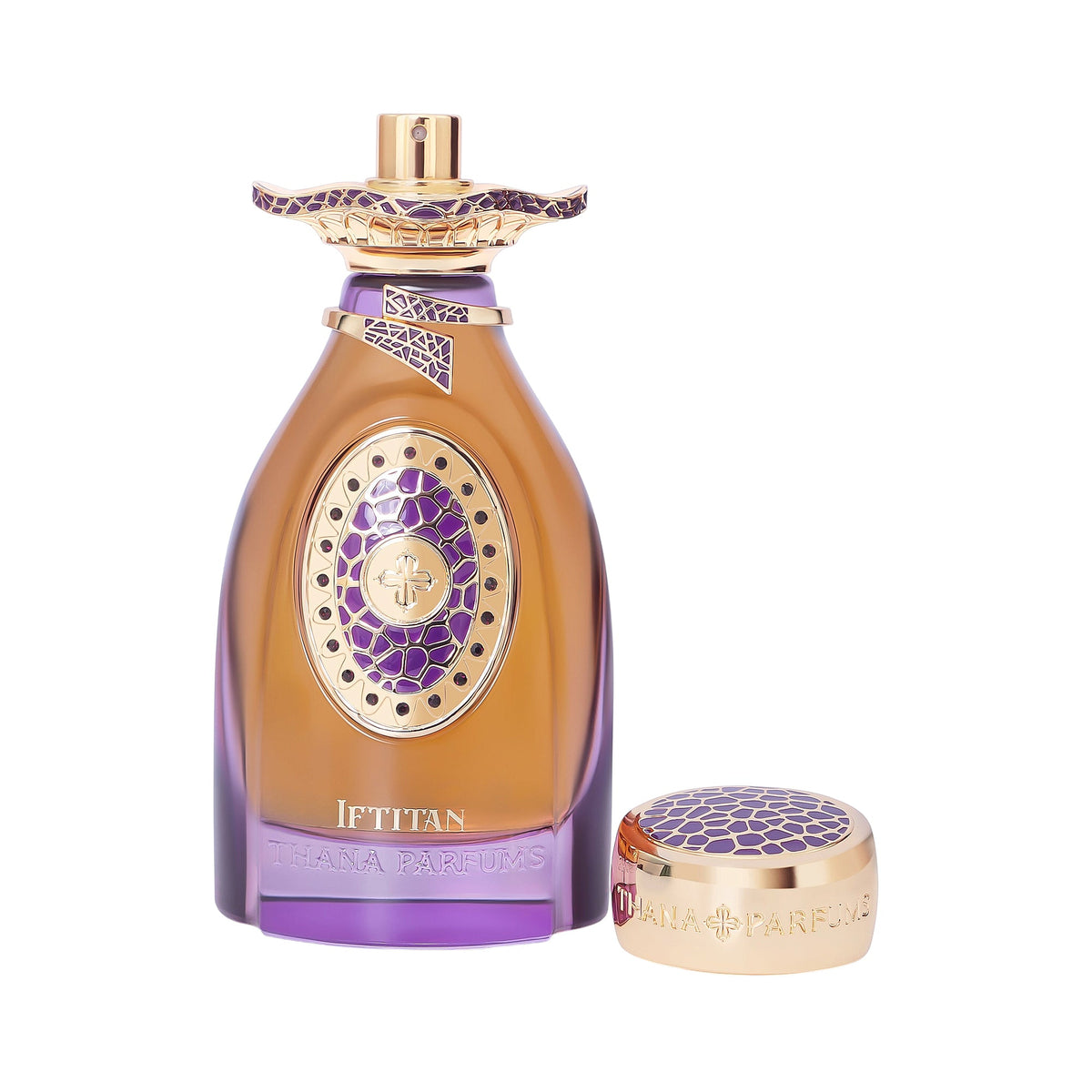 Amber perfume bottle with purple glass base, gold-toned oval emblem with purple pattern, and gold-toned collar. Gold-toned ca