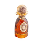 Amber glass perfume bottle with a gold-toned spherical cap and ornate collar, both featuring textured brown patterns. Gold-to