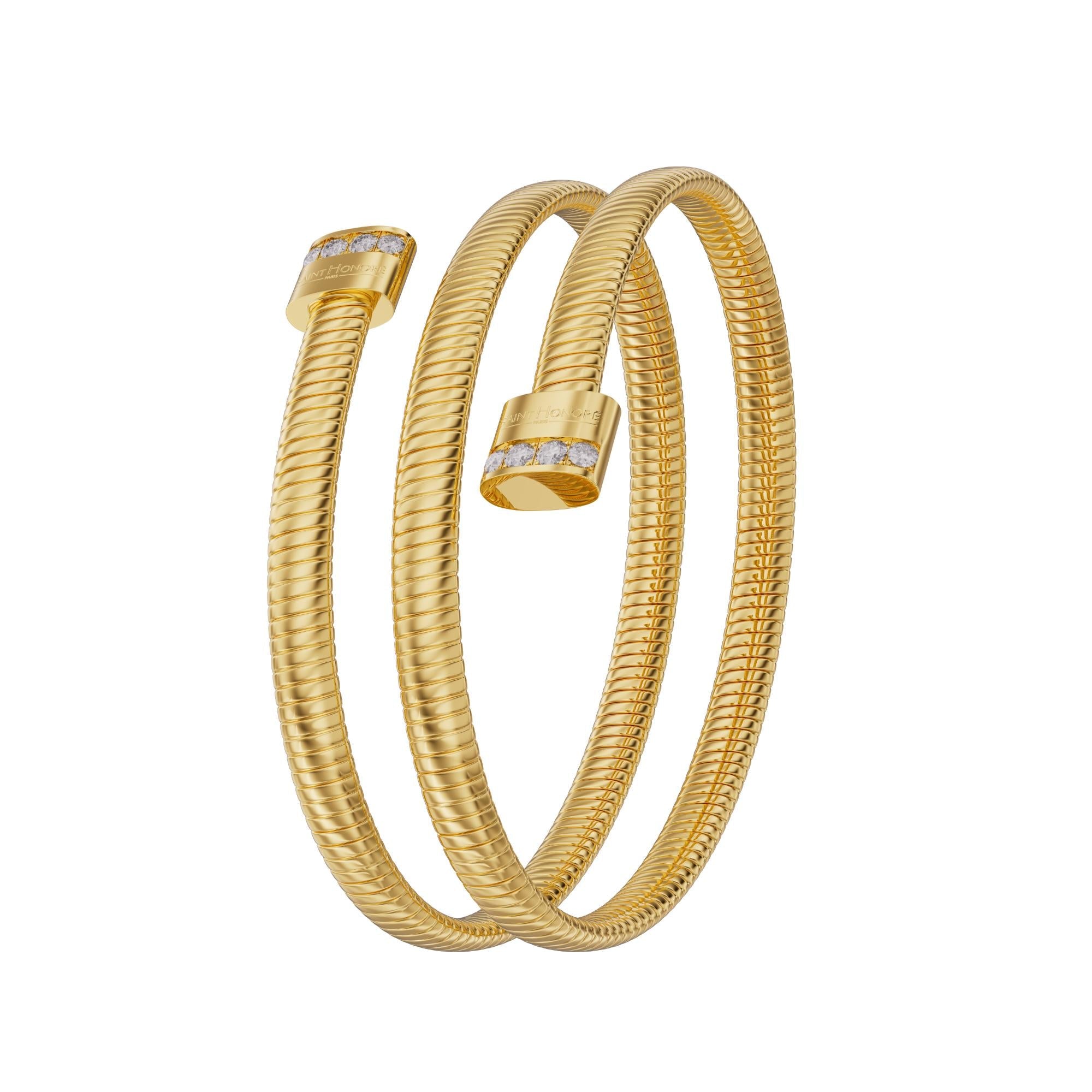 A three-quarter vertical display of the gold coiled Tubogas bangle, showing the smooth spiral layers and the side-aligned crystal detailing on the rounded end caps.