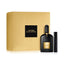 Tom Ford Black Orchid gift set featuring a large ribbed gold presentation box with a black logo square, a ribbed black 50ml perfume flacon with a gold label, and a matching sleek black travel atomizer.
