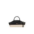 Piumelli Vela structured handbag with black leather upper and cream fabric lower, featuring two top handles and a gold-toned