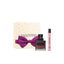 A Valentino Donna Born In Roma Intense gift set featuring a 50ml studded glass fragrance bottle with a dark burgundy gradient, a slim 15ml travel spray, and a cream-colored gift box decorated with gold stars and a large purple bow.