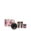 Versace Crystal Noir pour femme gift set featuring a deep burgundy and white baroque patterned box, a round black vanity bag with gold zippers, perfumed bath and shower gel, body lotion, and the signature dark glass perfume flacon with a jewel-cut cap.