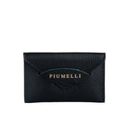 Black pebbled leather cardholder with a flap closure. The Piumelli brand name is embossed in gold-toned lettering on the fron