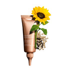 Clarins Extra-Firming neck & décolleté care in a rose gold-toned squeeze tube with a ribbed, pointed applicator tip.