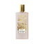 Frosted light pink rectangular perfume bottle with a gold-toned hexagonal cap and a gold-toned label depicting Parisian rooft