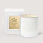White cylindrical candle with embossed crests and horses, and a gold-toned lid embossed with 'CREED 1760'.