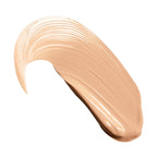 A curved swatch of light beige liquid concealer with visible brush strokes and a glossy finish.