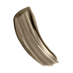 A curved swatch of medium taupe liquid makeup with a satin finish and visible brush strokes, tapering at one end.