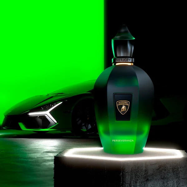 Faceted dark green perfume bottle with a matte top, translucent bottom, gold-toned Lamborghini logo, and a spire-shaped cap.