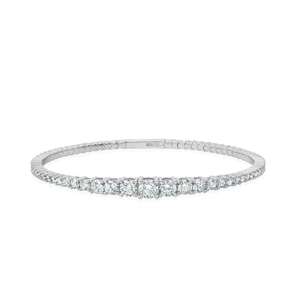 Silver-toned stretch cuff bracelet with a continuous line of clear, round, graduated cubic zirconia stones.