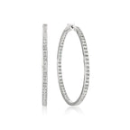 Pair of silver-toned inside-out hoop earrings with clear sparkling stones set along both inner and outer surfaces.