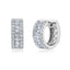 Pair of silver-toned huggie earrings, each featuring a central row of clear baguette stones flanked by two rows of clear roun