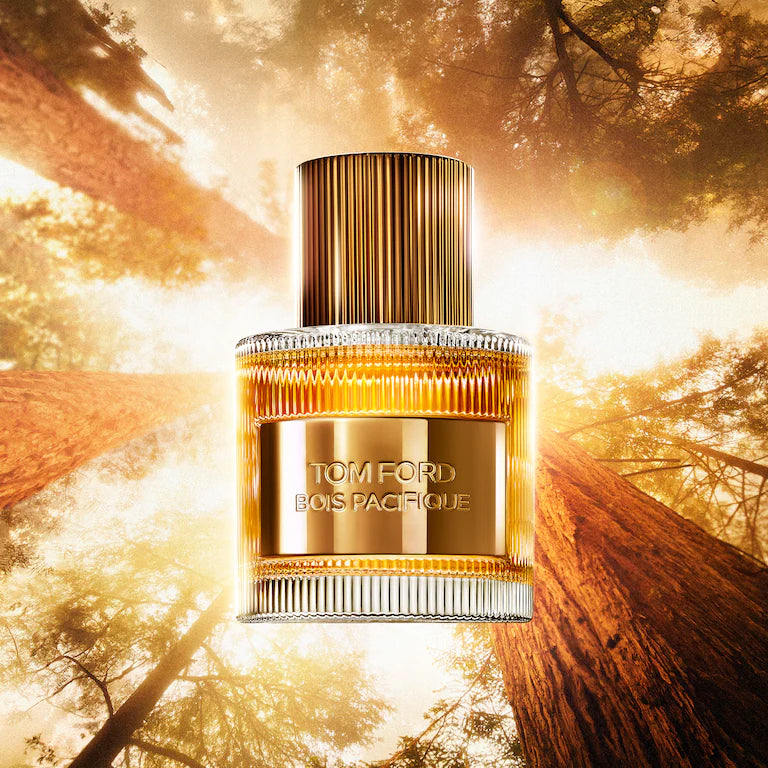 Tom Ford Bois Pacifique perfume bottle: clear glass with golden liquid, gold-toned label, ribbed gold-toned cap, and ridged g