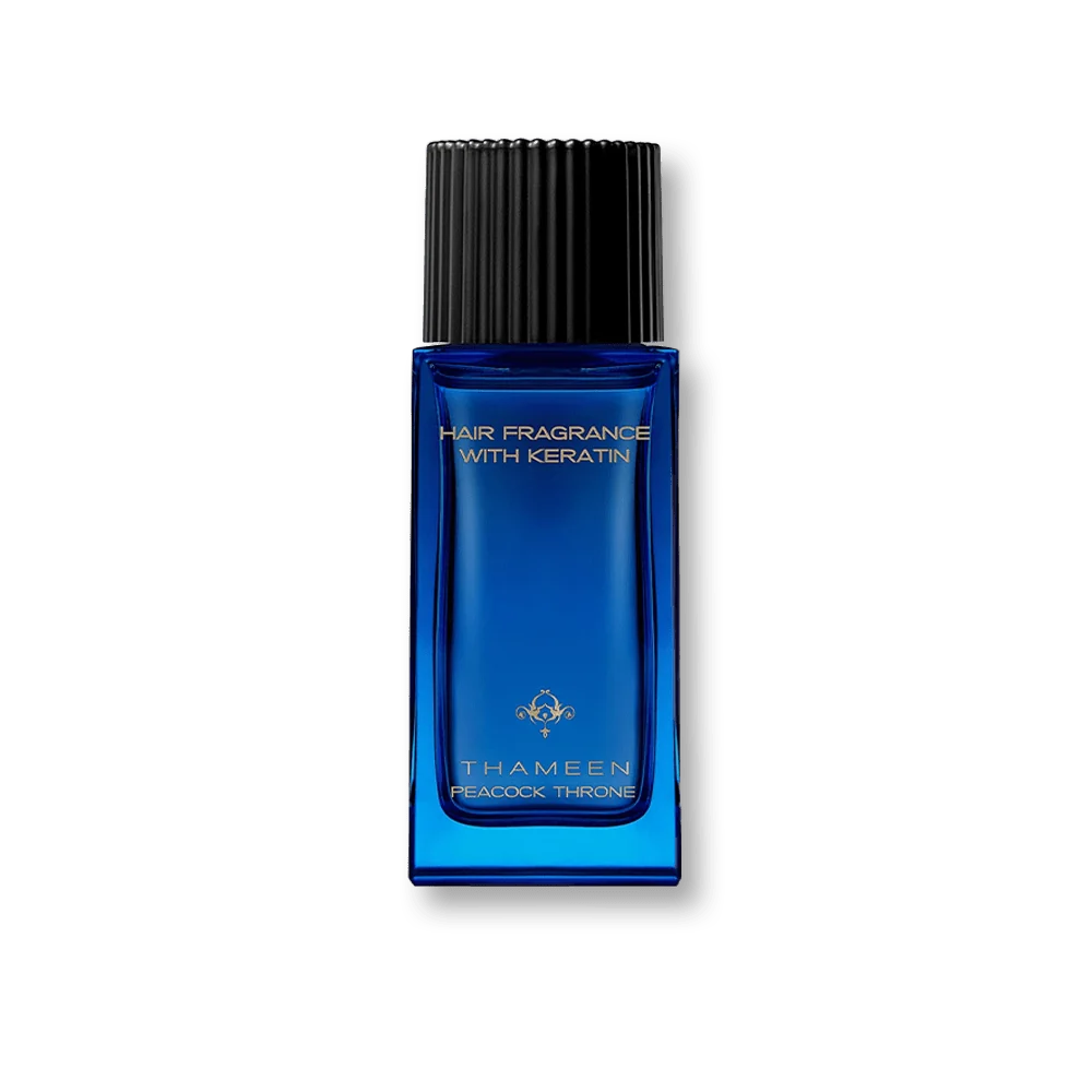 Blue rectangular hair fragrance bottle with a black ribbed cap, gold-toned text, and emblem.