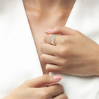 Gold-toned ring with three large, round, clear stones set across the top.
